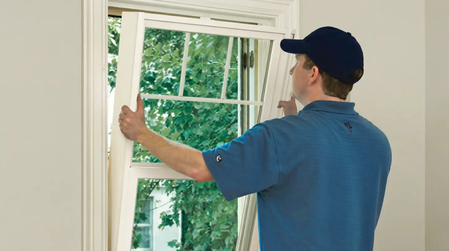Professional contractors performing a residential window insulation and replacement service in Nashua, NH